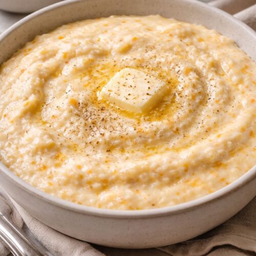 Creamy Southern grits with butter and black pepper served in a bowl