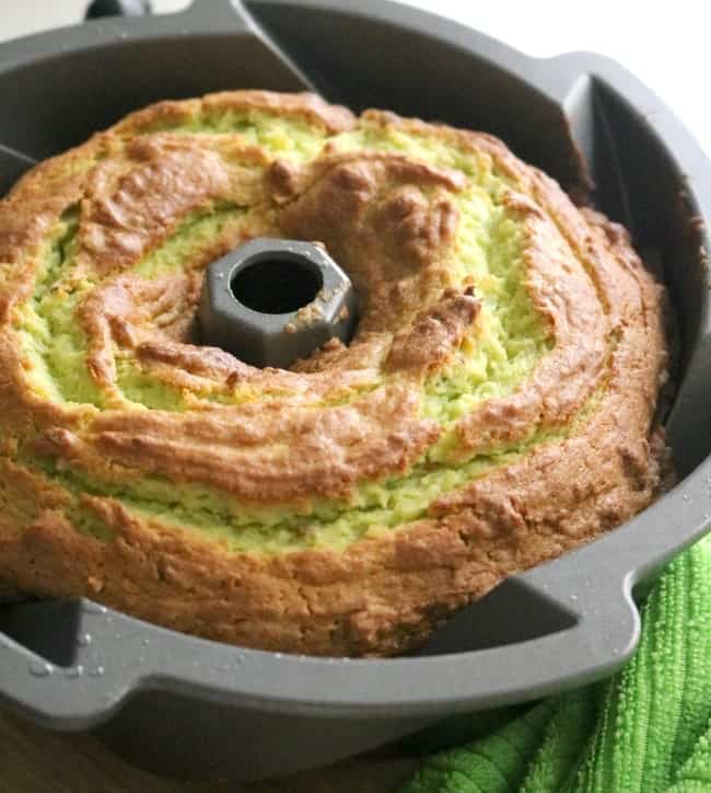 Pistachio Bundt cake in the heritage style deeply fluted bundt pan waiting to be turned out onto the wire rack.