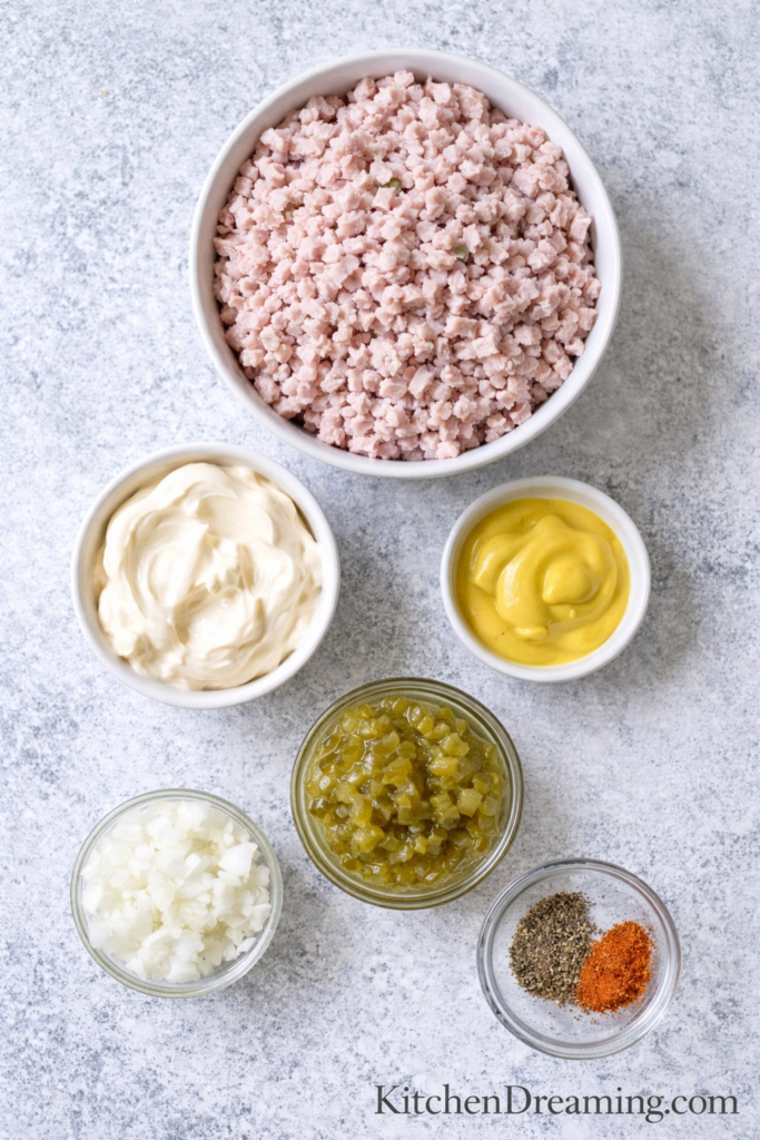 Best Ham Salad Recipe – Old Fashioned, Creamy, Easy to Make 2 Ingredients for ham salad recipe arranged in bowls overhead on a light surface.
