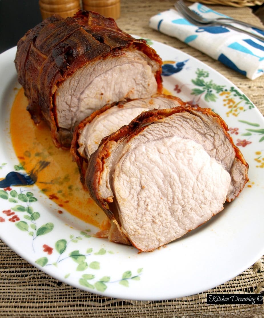This Bacon Wrapped Pork Loin is so tender it can be cut with a fork. The smoked paprika lends a distinct flavor to the meat and aroma to the kitchen.