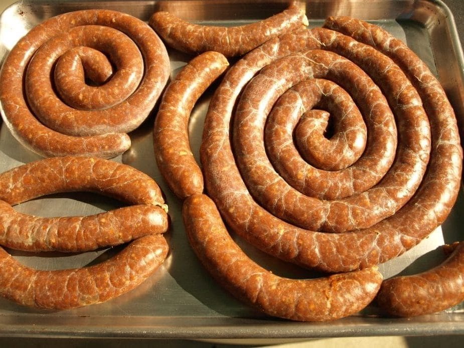 A tray of homemade linguica Portuguese smoked sausage after it is done smoking.