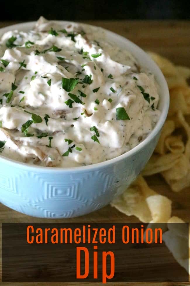 A bowl of our amazing caramelized onion dip recipe. Chips are scattered on the table around the bowl.