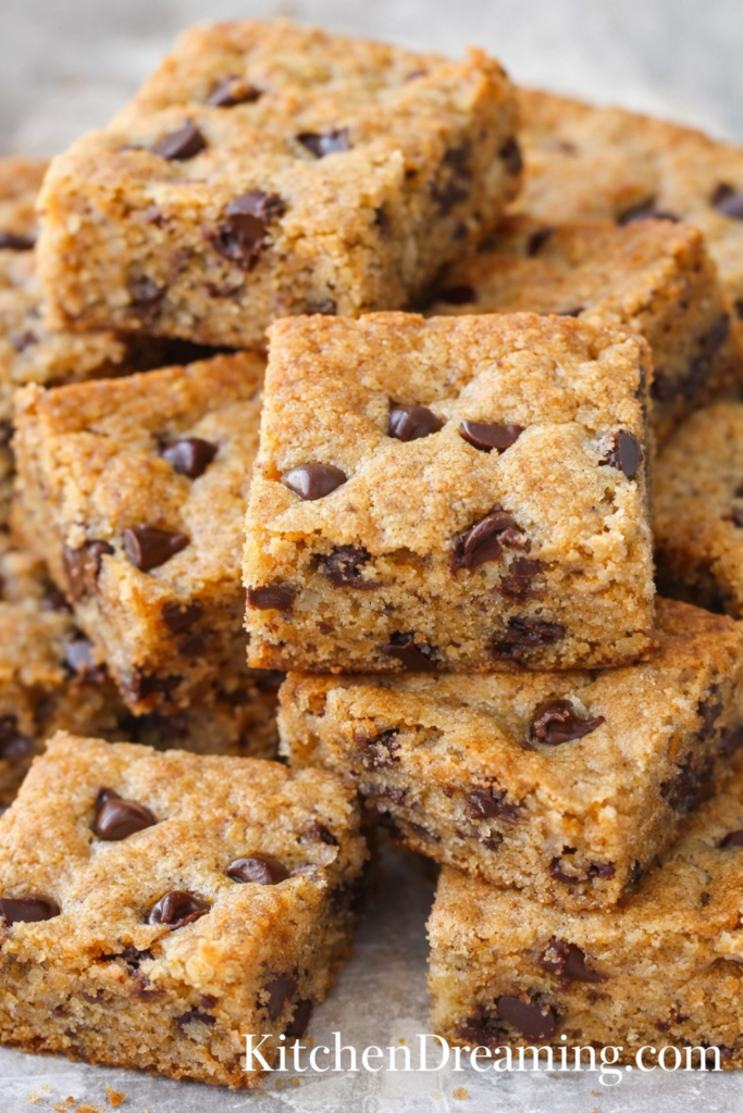 Chewy Chocolate Chip Blondies (Plus Sweet and Savory Add-In Ideas) 1 Blondies recipe hero image of stacked chocolate chip blondies with chewy centers.