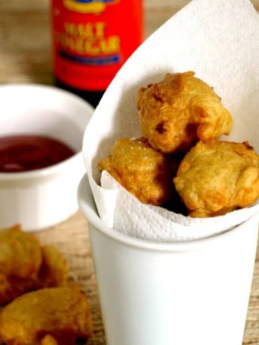 clam cakes in a cup lined with paper towels to drain any oil.