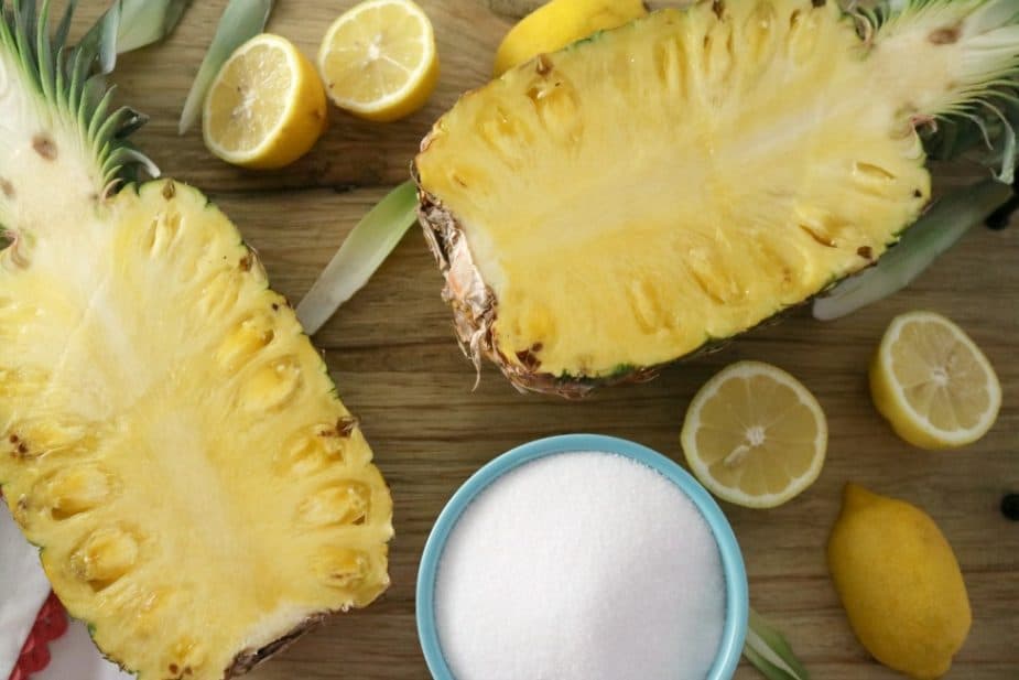 An image showing the ingredients needed to make pineapple jam. Fresh pineapple, sugar, and fresh lemon juice. 