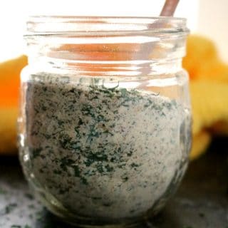 a jar of dry ranch seasoning with a measuring spoon sticking out of the top of the open jar.