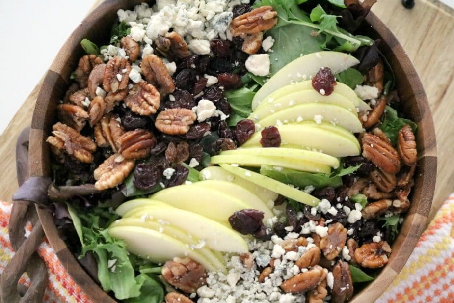 An overhead shot of Apple Pecan Blue Cheese Salad with Apple Vinaigrette in a wooden bowl.