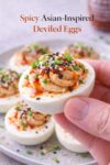 Asian-inspired spicy sriracha deviled eggs with creamy filling topped with sesame seeds, green onions, and a drizzle of sriracha.