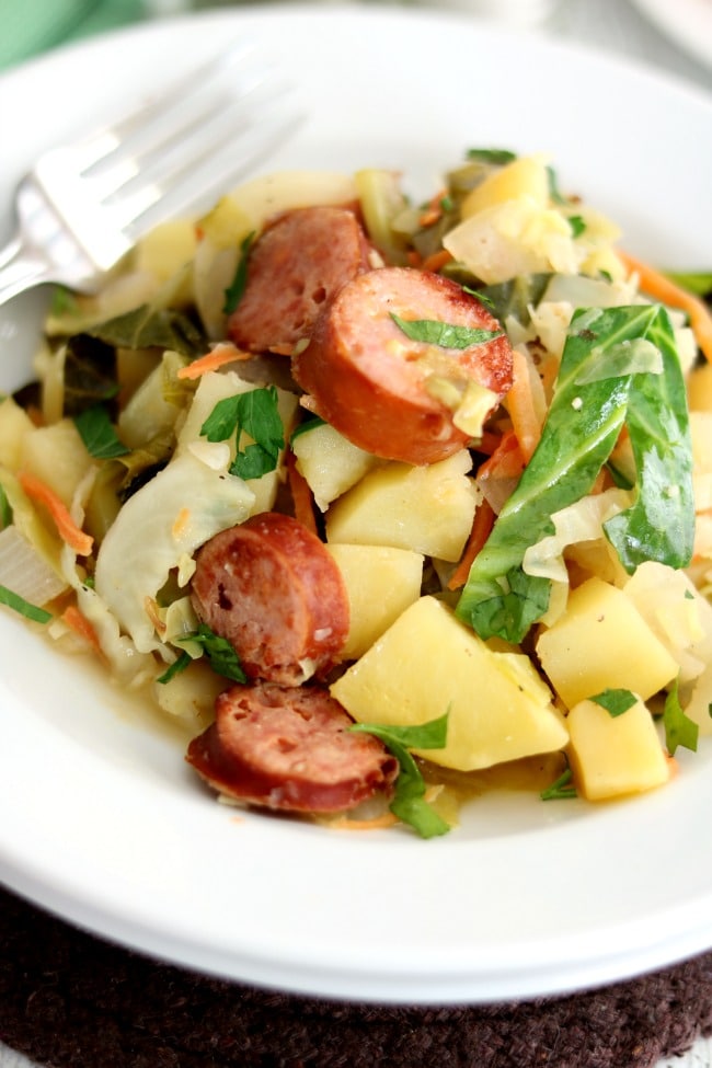 This German-inspired Smoked Sausage Recipe pairs sausage rounds with braised cabbage and potatoes and is seasoned with fennel and caraway. #Kroger #Hillshire Farm #Smoked Sausage