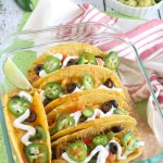 Tender and juicy Shredded Mexican Style Chicken is layered into crispy Taco shells, topped with shredded cheese and baked to golden perfection in the oven to create these Baked Chicken Tacos. What my family loves about it is that we can each add just whatever toppings we like in any quantity we chose. YUMM!