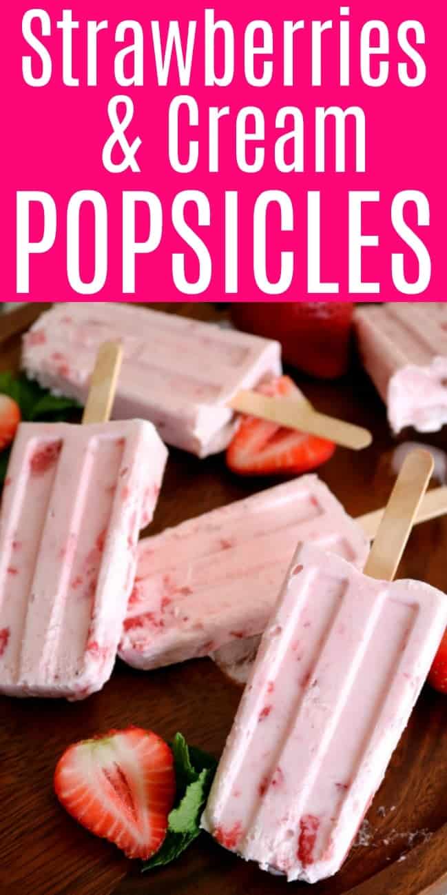 Strawberry cream Popsicle on a tray with sliced strawberries.