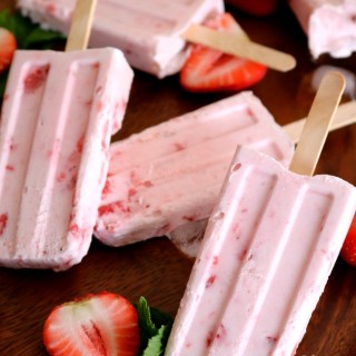 strawberry cream popsicles on a tray