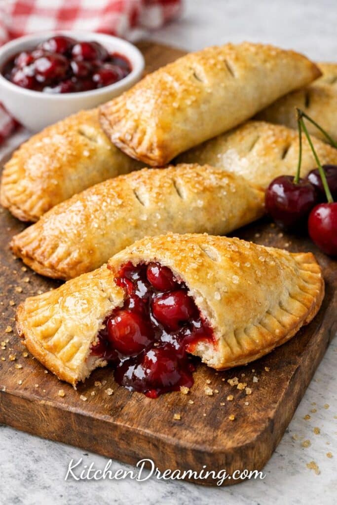 Easy cherry hand pies made with empanada dough, baked golden and flaky with juicy cherry filling.