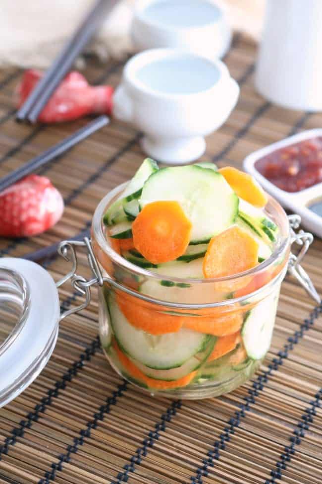 A jar of pickled vegetables on a dinner table