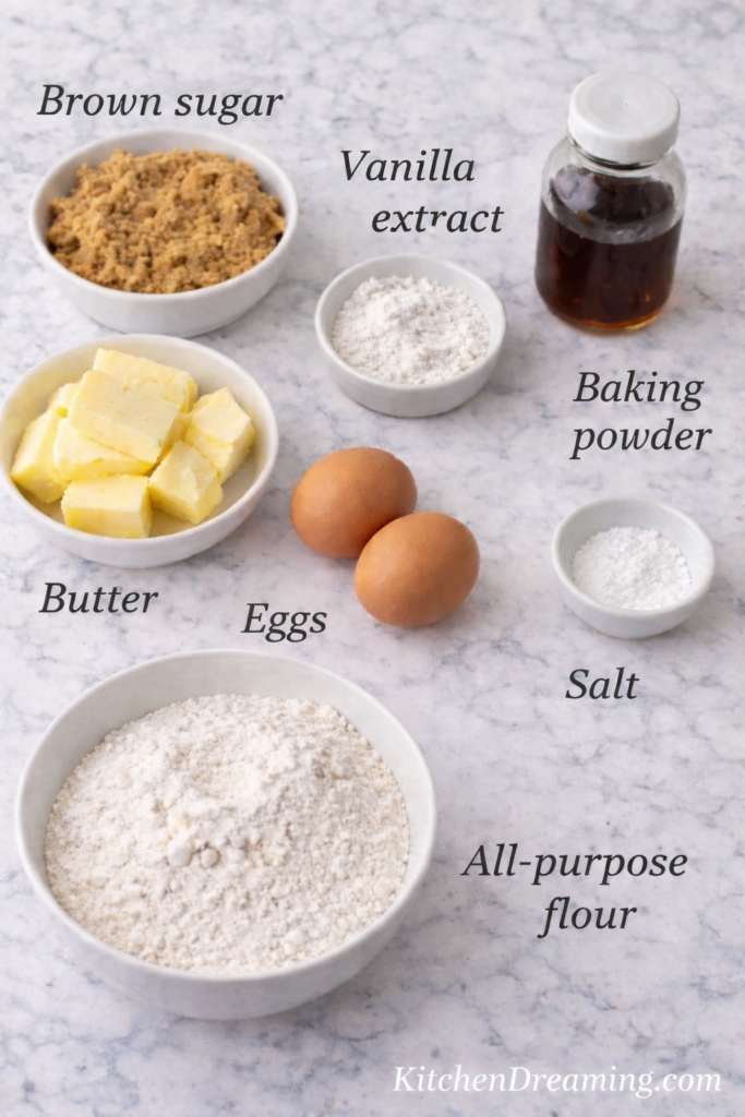 Chewy Brownie Recipe with Brown Sugar (Easy From Scratch) 3 Labeled ingredient flat lay for a chewy brownie recipe with brown sugar, butter, eggs, vanilla extract, all purpose flour, baking powder, and salt.