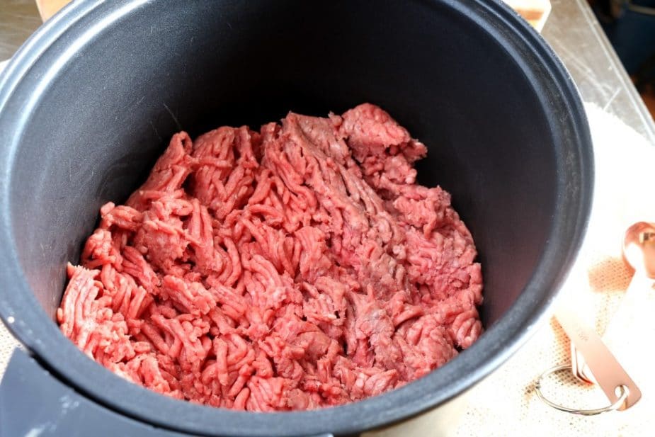 Lean ground beef in the slow cooker insert ready to be prepared for tacos.
