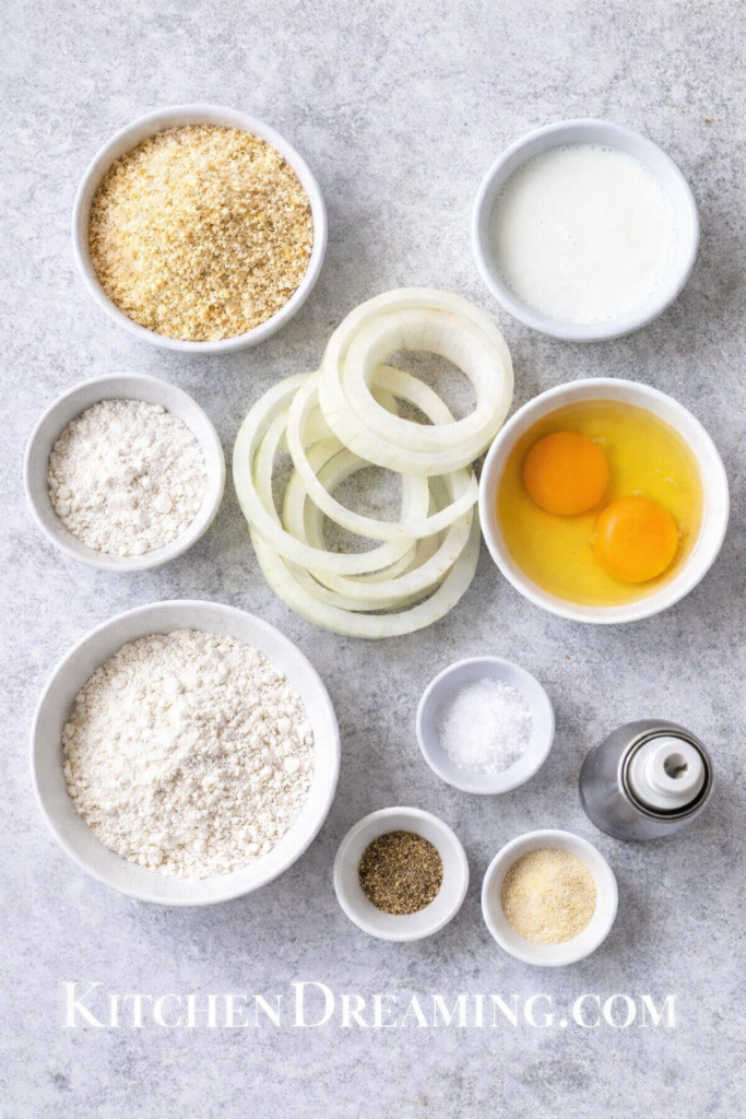 Crispy Air Fryer Onion Rings Recipe (Easy Homemade Version) 2 Ingredients for air fryer onion rings arranged in overhead flat lay.