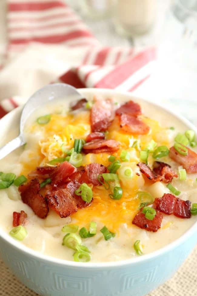 A close up photo of a bowl of loaded baked potato soup with wright brand bacon.
