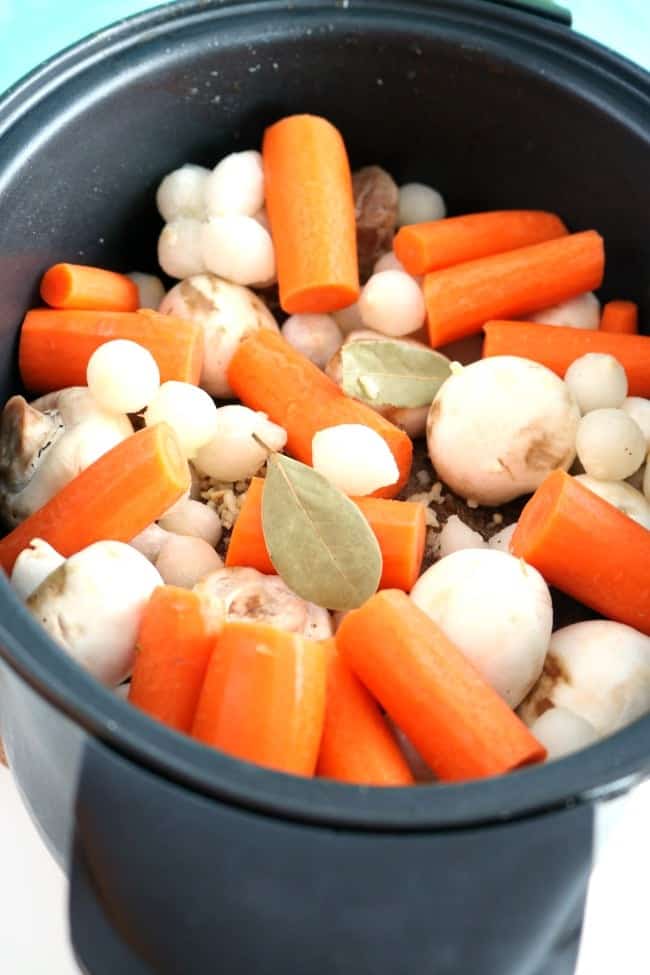 a crock pot filled with the ingredients for crock pot pot roast