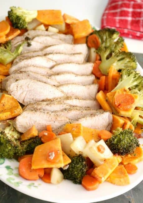 Tender and juicy marinated pork roasts in the oven with seasonal vegetables for a comforting, nutritious, and easy dinner! This Roasted Pork Tenderloin comes together with only 10 minutes of preparation!