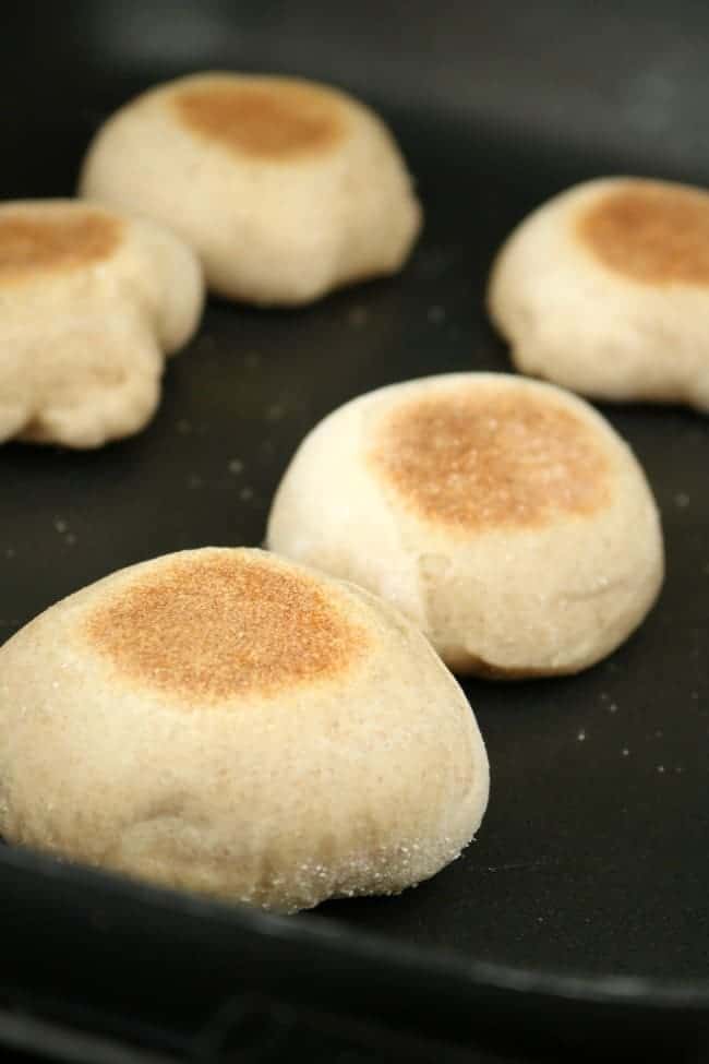 English muffins cooking in a hot skillet