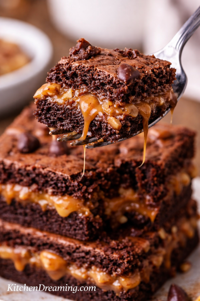 Caramel Brownies (No Fail Gooey Layers Every Time) 5 Stacked caramel brownies with thick fudgy chocolate layers and a gooey caramel center, a caramel brownies recipe hero image for KitchenDreaming.com.