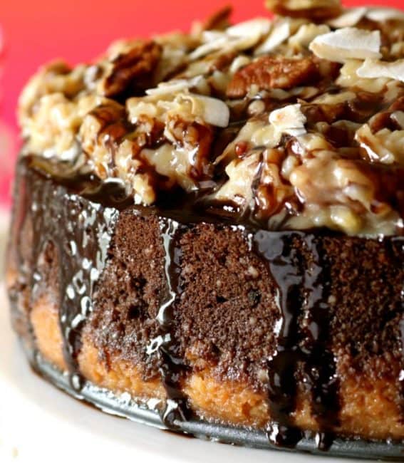 A close-up photo of the side and coconut-pecan topping of a German Chocolate cheesecake.