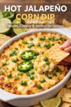 A bubbling dish of baked jalapeño corn dip topped with melted cheese and jalapeño slices, served with tortilla chips as an easy party appetizer.