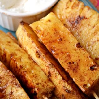 Fresh cut pineapple spears tossed with brown sugar and cinnamon and then grilled to absolute perfection. This Grilled Pineapple will easily become your new favorite recipe this grilling season!