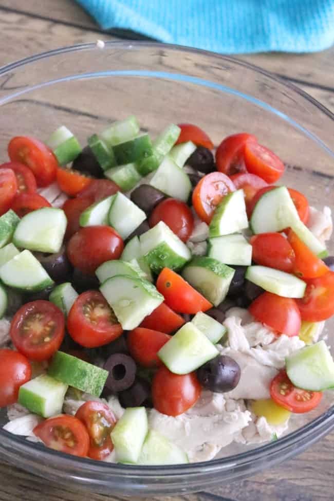 This Easy Greek Chicken Salad is loaded with fresh Mediterranean ingredients like fresh lemon juice, olives, tomatoes, cucumber, Greek yogurt, and feta cheese. This make-ahead dish is perfect for summer entertaining. cucumber, and feta cheese.