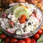 This Easy Greek Chicken Salad is loaded with fresh Mediterranean ingredients like fresh lemon juice, olives, tomatoes, cucumber, Greek yogurt, and feta cheese. This make-ahead dish is perfect for summer entertaining.