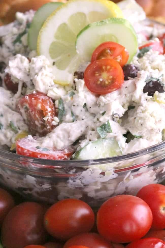 This Easy Greek Chicken Salad is loaded with fresh Mediterranean ingredients like fresh lemon juice, olives, tomatoes, cucumber, Greek yogurt, and feta cheese. This make-ahead dish is perfect for summer entertaining. 