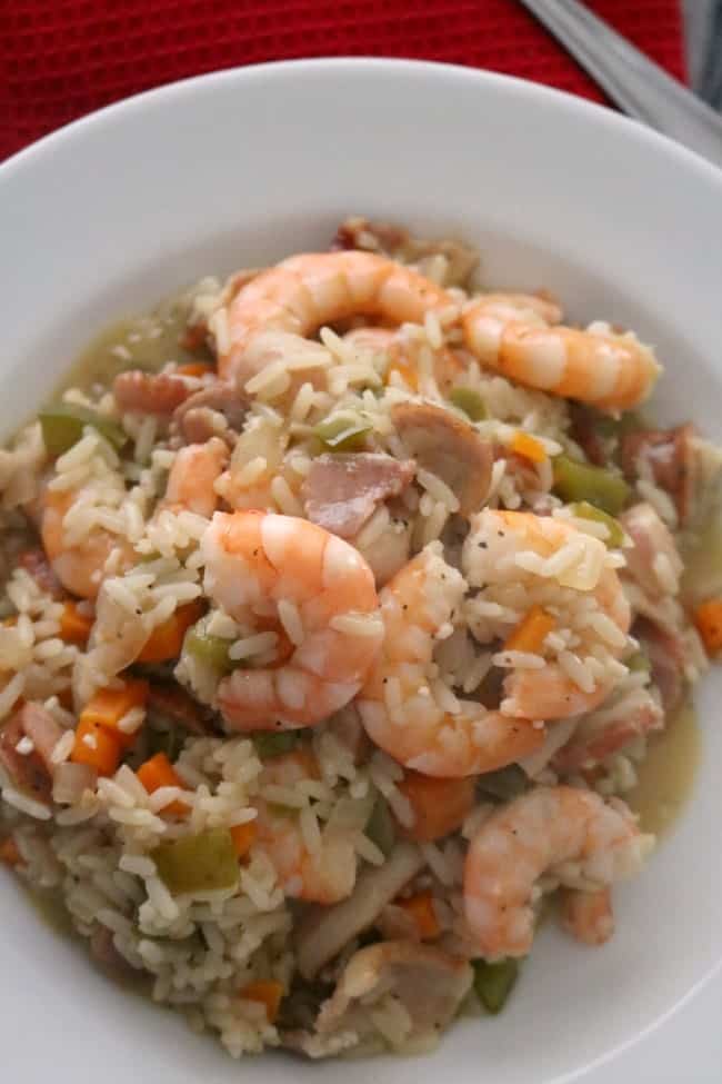One-pot Lowcountry Shrimp Perloo is simple to make and rich in flavors and tradition. Shrimp Perloo is a rice dish made with locally grown rice and local, fresh shellfish. Similar to jambalaya and paella, perloo starts with a flavorful base of rice simmered with bell pepper, carrots, garlic, and onion. 