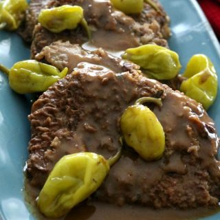 Scratch-made Mississippi Swiss Steaks are tender and juicy covered in a rich, tangy beef gravy. This modified version of the iconic pot roast doesn't use prepackaged seasoning mixes and is still a quick and easy weeknight meal.