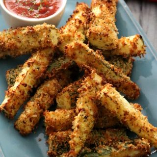 Baked Parmesan Zucchini Fries are a great no-fuss way to get kids (and adults) to eat their vegetables. Crisp on the outside and creamy on the inside with a nice bit of saltiness from the Parmesan cheese these fries are your new favorite way to eat zucchini. Served with a marinara, these make a great kid friendly and figure-friendly appetizer or side dish.