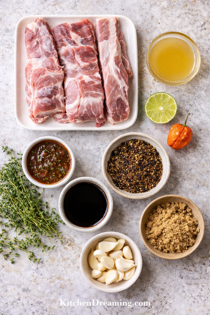 Instant Pot Jamaican Jerk Pork Ribs (Tender and Spicy) 2 Jamaican Jerk Pork Ribs, overhead flat lay of ribs, jerk seasoning, lime, thyme, and peppers.