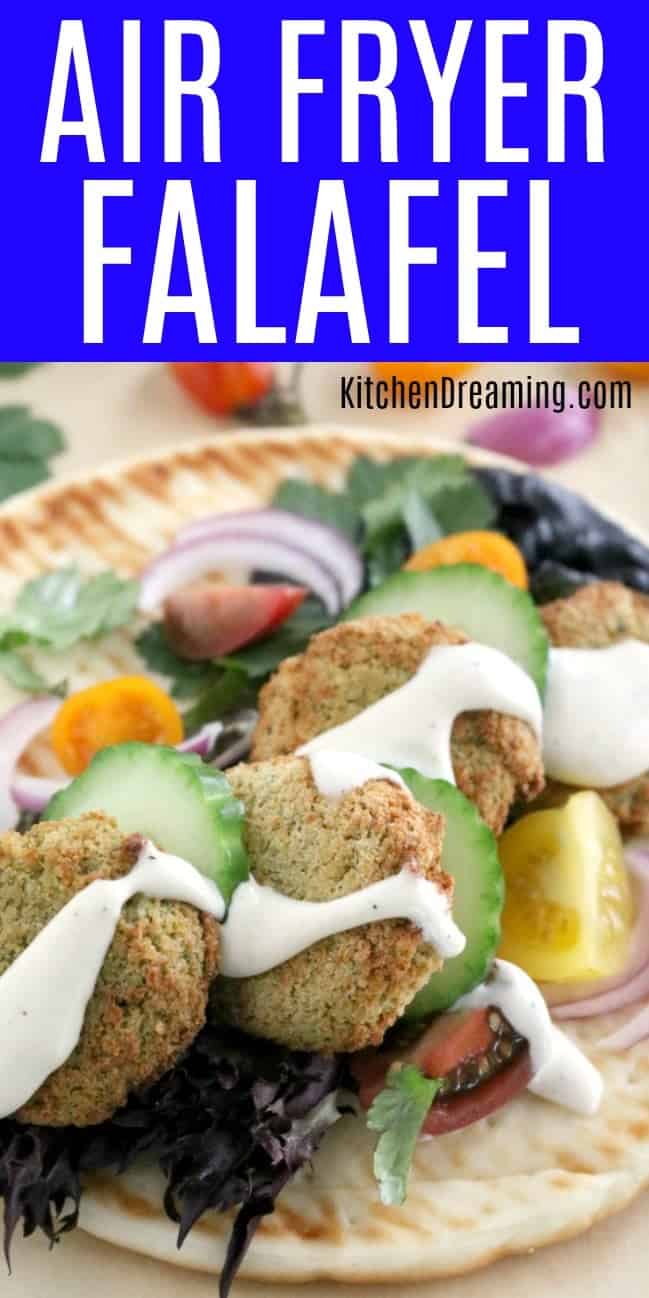 a pinnabble image of Air Fryer Falafel on pita bread topped with cucumbers, red onions, tomatoes, and tatziki sauce. 