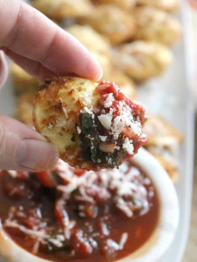 A fried ravioli dipped in marinare sauce