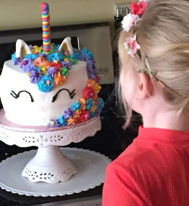 my daughter and her unicorn cake