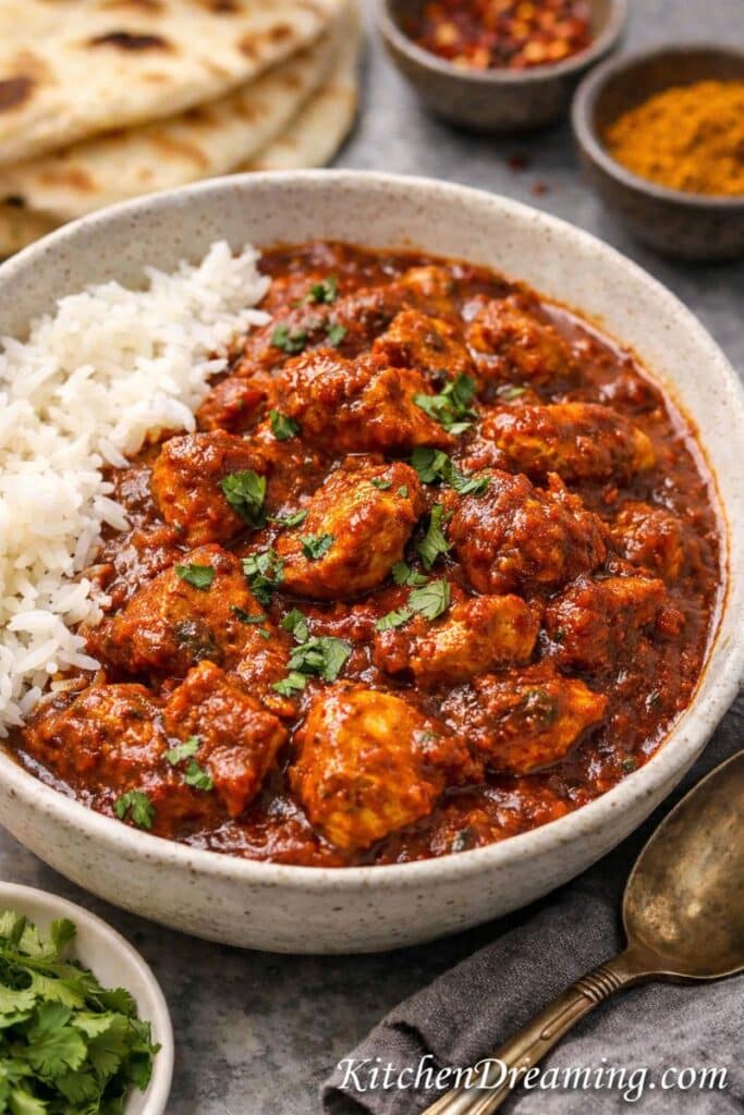 Easy chicken vindaloo recipe served with rice in a bowl, a quick and tangy Indian chicken curry for weeknight dinner.