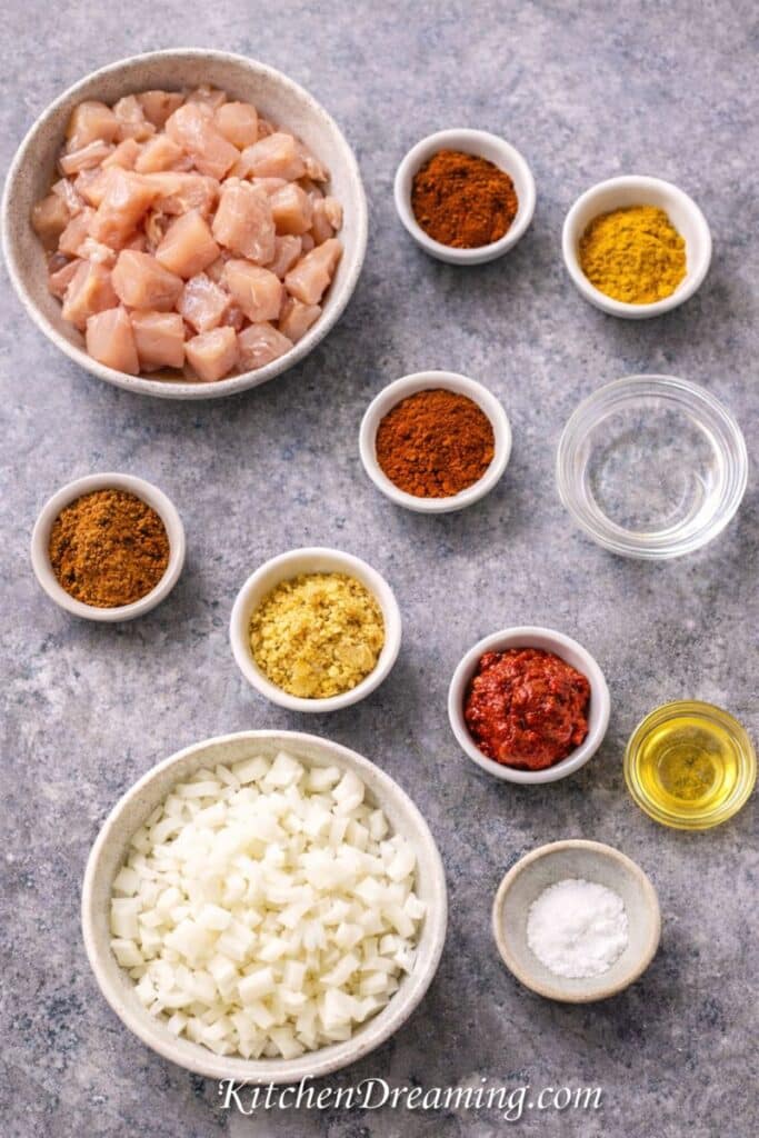 Chicken vindaloo ingredients flat lay for an easy chicken vindaloo recipe, showing pantry spices and staples for a quick Indian curry.