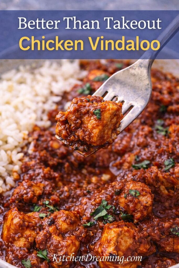 Better than takeout chicken vindaloo with a fork bite, showing rich sauce and tender chicken in an easy chicken vindaloo recipe.