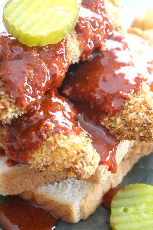 Close up of Air Fryer Nashville Hot CHicken Tenders piled high on white bread