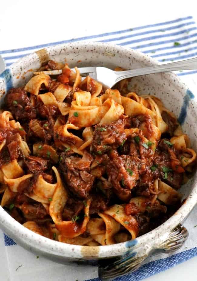 A bowl of Beef Ragu with pasta - A staple of northern Italy, a ragu is a thick, full-bodied meat sauce that usually contains beef, tomatoes, onions, celery, carrots, and garlic. The already flavorful sauce is then further enhanced with wine and herbs. #Italian #Beef #Ragu #Sauce #Pasta #KitchenDremaing