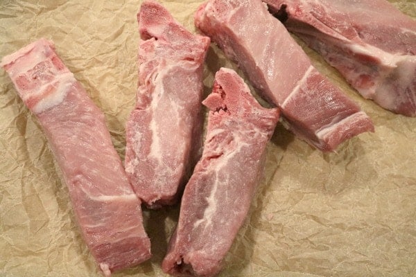 An image of raw pork ribs showing the color and marbling you want to see when you purchase ribs at the butcher.
