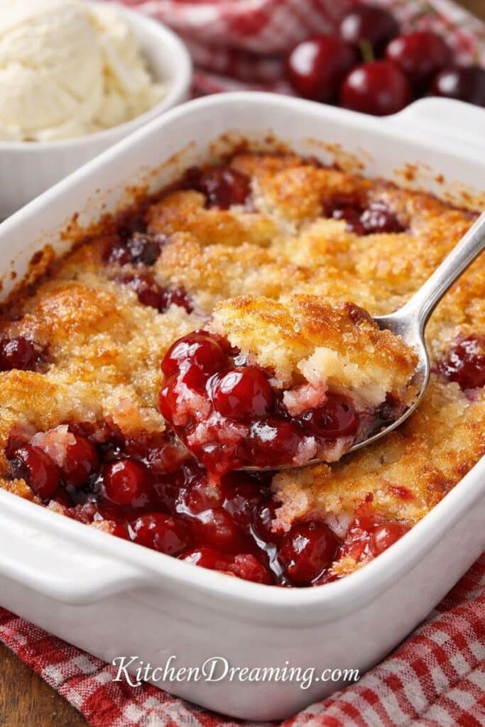 Easy cherry cobbler with magic crust, featuring a close-up of golden buttery crust and bubbling cherry filling; quick, homemade dessert recipe.