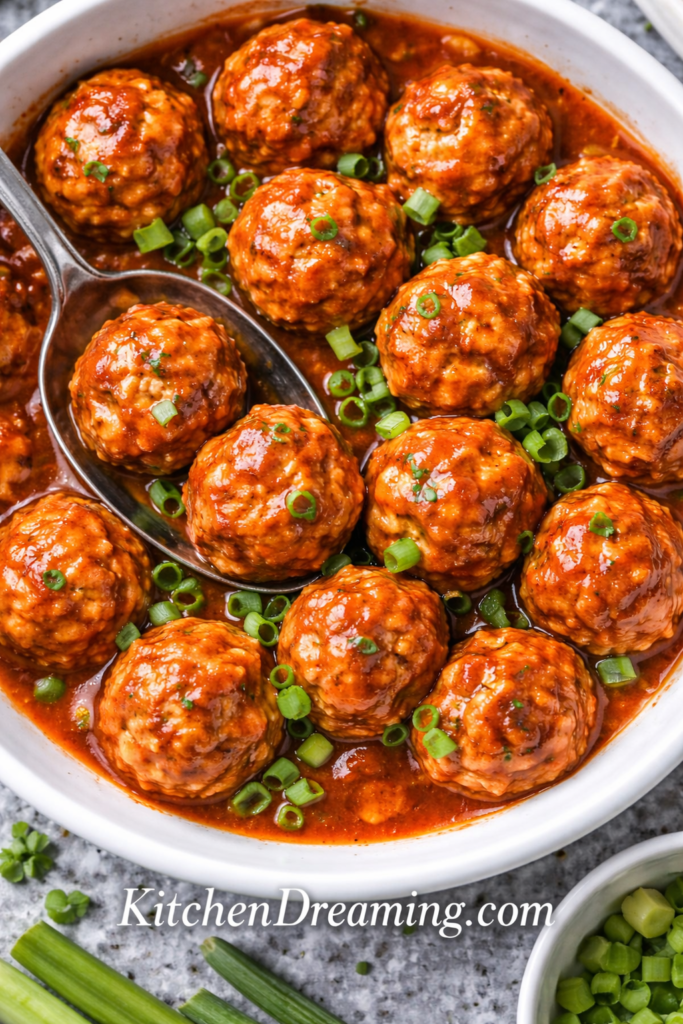 Crock Pot Buffalo Chicken Meatballs Recipe (Easy Slow Cooker Appetizer) 6 buffalo chicken meatballs recipe close up showing glossy buffalo sauce and tender meatballs