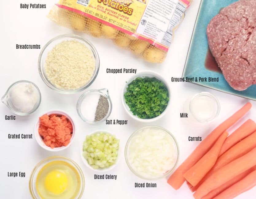 A table of ingredients for Instant Pot meatloaf: minced beef, baby potatoes, breadcrumbs, salt and pepper, chopped parsley, garlic, carrots, egg, celery, onions, milk, and carrots. 