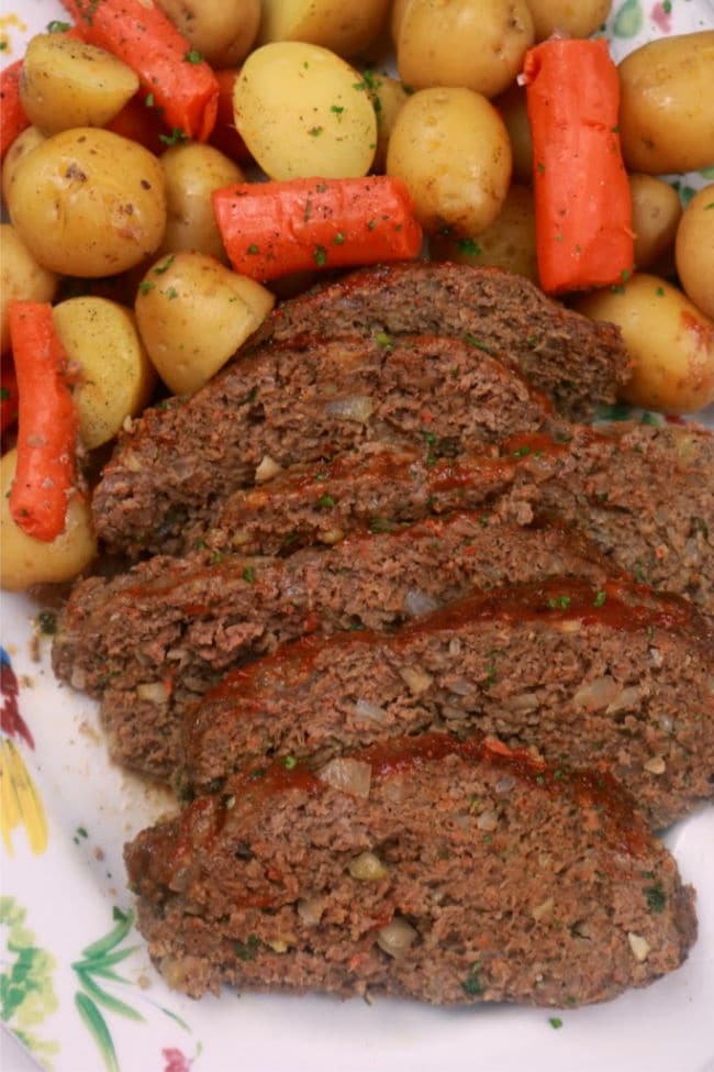 A platter of sliced meatloaf and steamed vegetables from the instant pot.