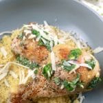 Baked Garlic Parmesan Chicken Plated in a shallow bowl over couscous with parmesan cheese 1